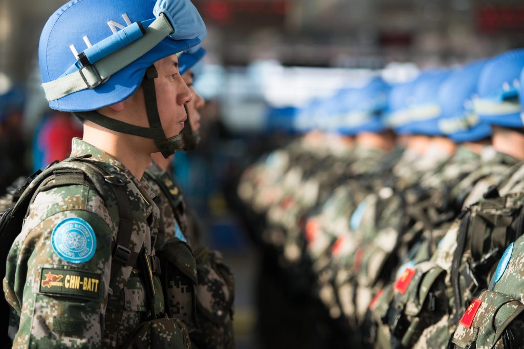 UN security team in camouflage and blue helmets with guns and bulletproof vests in china
